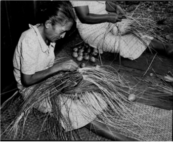 Woman weaving hat in 1935..png